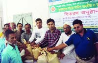 GANGACHARA (Rangpur): Asaduzzaman Bablu, Chairman, Gangachara Upazila Parishad distributing seed and fertilizer among the farmers at Upazila Parishad premises as Chief Guest on Tuesday.