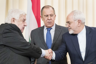 Russian Foreign Minister Sergey Lavrov, (centre), stands in the middle as Syrian Foreign Minister Walid Muallem, (left) and Iranian Foreign Minister Mohammad Javad Zarif shake hands after a shared press conference following their talks focused on Syria in