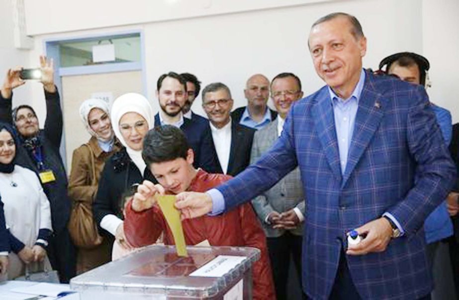 Turkish President Tayyip Erdogan with his wife Emine casts his ballot at a polling station during a referendum in Istanbul, Turkey on Sunday.