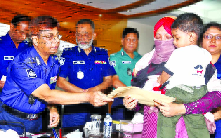 Inspector General of Police AKM Shahidul Haque handing over cheque of grant aid among the families of those who were killed and wounded in anti-militants raid in Sylhet at the Police Headquarters on Sunday.