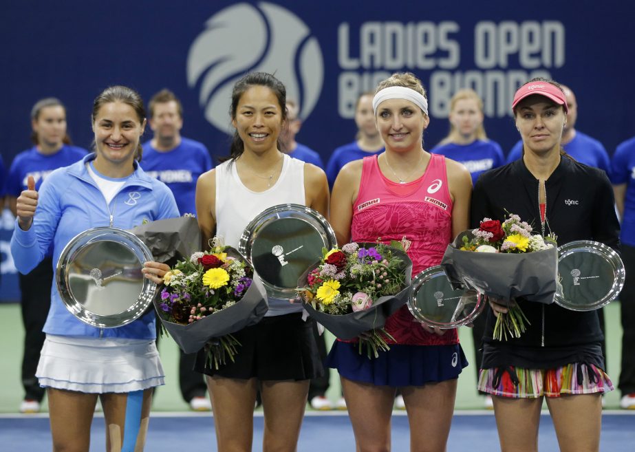 Winners Monica Niculescu of Romania (left) and Hsieh Su-wei of Taiwan (second left) and second placed Timea Bacsinszky and Martina Hingis of Switzerland (right) pose during the flower ceremony after the final doubles match, at the WTA Ladies Open tennis