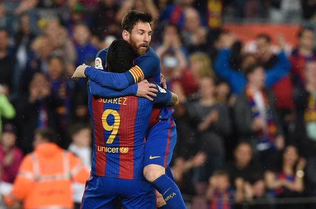 Barcelonaâ€™s Argentinian forward Lionel Messi celebrates with Barcelonaâ€™s Uruguayan forward Luis Suarez after scoring a goal during the Spanish league football match FC Barcelona vs Real Sociedad at the Camp Nou stadium in Barcelona on Satur