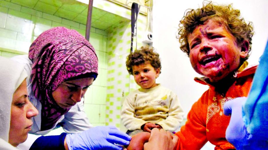 Injured children receive treatment in government-held Aleppo.