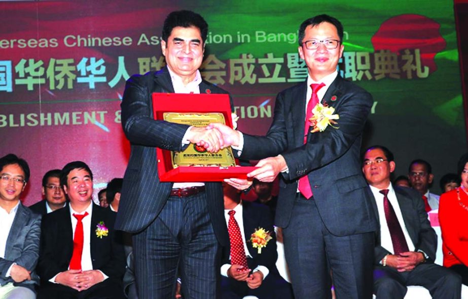 Dr H.B.M.Iqbal, Chairman of Premier Bank Ltd, receiving Crest from Zhuang Lifeng, President of Overseas Chinese Founding at a local hotel in the city recently. Ma Mingquing , Chinese Ambassar to Bangladesh and the bank's Managing Director Khondker Faz
