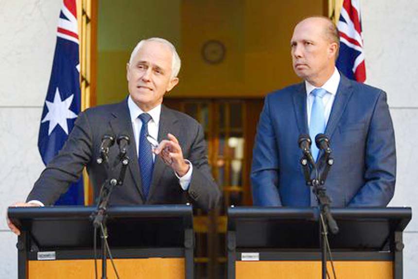 Australia's Prime Minister Malcolm Turnbull speaks as Immigration Minister Peter Dutton listens on during a media conference at Parliament House in Canberra on Tuesday.