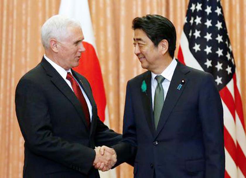 U.S. Vice President Mike Pence (L) is welcomed by Japan's Prime Minister Shinzo Abe at their meeting at Abe's official residence in Tokyo on Tuesday.