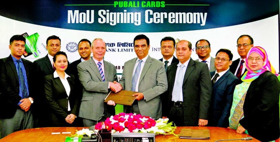 Md Abdul Halim Chowdhury, Managing Director of Pubali Bank Ltd and James P. McDonald, General Manager of Intercontinental Dhaka, exchanging a MoU signing documents at the bank's head office on Tuesday. Under the deal, Global Credit Card members of the ba