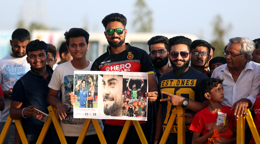 Fans queue up with posters of Virat Kohli ahead of the start of play between Royal Challengers Bangalore and Gujarat Lions, Rajkot in IPL 2017 at Bangalore on Tuesday.