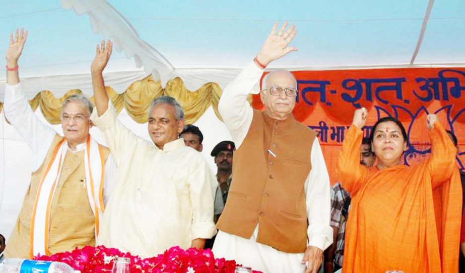 Indian opposition leader and President of the Bharatiya Janta Party (BJP) L.K. Advani, second right, senior BJP leaders Uma Bharati, right, Kalyan Singh, second left, and Murli Manohar Joshi wave to people during a public rally in Rae Bareilly, in the nor