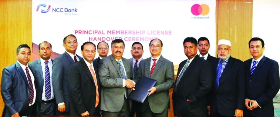 Golam Hafiz Ahmed, Managing Director of NCC Bank and Syed Mohammad Kamal, Country Manager of Mastercard Bangladesh, sign an agreement to be a principal member of the payment system at the bank's head office recently.