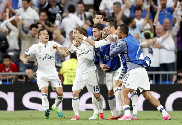 Real Madrid's Cristiano Ronaldo (2nd right) celebrates after scoring his side's second goal during the Champions League quarterfinal second leg soccer match between Real Madrid and Bayern Munich at Santiago Bernabeu stadium in Madrid, Spain on Tuesday.