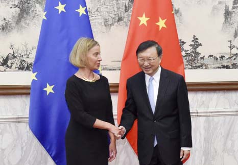 Federica Mogherini, left, high representative of the European Union for Foreign Affairs and Security Policy, shakes hands with Chinese State Councilor Yang Jiechi before their meeting at Diaoyutai State Guesthouse in Beijing on Wednesday.