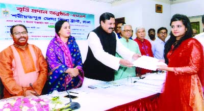 Shipping Minister Shajahan Khan MP distributing scholarship among the students of SSC and HSC who achieved GPA-5 organised by Shariatpur District Education Trust as Chief Guest at CIRDAP Auditorium on Wednesday. Among others, Chairman of the Trust an