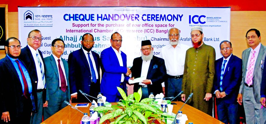 Abdus Samad Labu, Chairman of Al-Arafah Islami Bank Limited, handing over a claque of Tk.25 lakh to Mahbubur Rahman, President of International Chamber of Commerce of Bangladesh to purchase new office premises for the organization in the city recently. Md