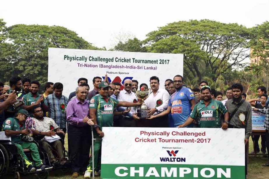 Bangladesh and India, the joint-champions of the Physically Challenged Tri-Nation T20 Cricket Tournament with the chief guest Deputy Minister for Youth and Sports Arif Khan Joy and the special guest Director of BCB Akram Khan pose with the championship tr