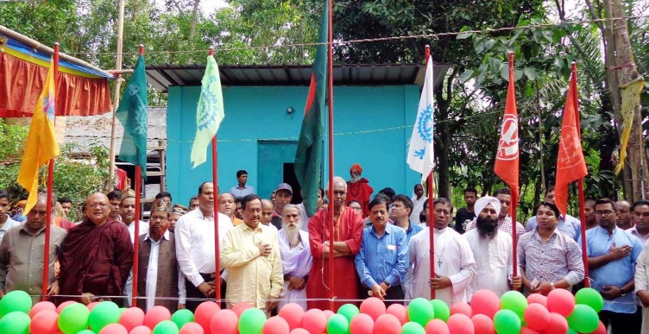 Principal of Shrine Swami Nittananda Puri Moharaj and General Secretary of Inter Religion Harmony freedom fighter Monoranjan Ghosal alongwith other guests hoisting flags of all religions in the inter- religion conference at Kelishahor, Patiya in Chit