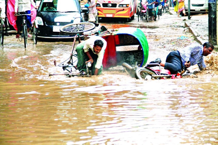 A motor cycle and a rickshaw alongwith-passengers fell on rain-fed road when both the vehicles got stuck in potholes near Mouchak-Malibagh flyover on Saturday.