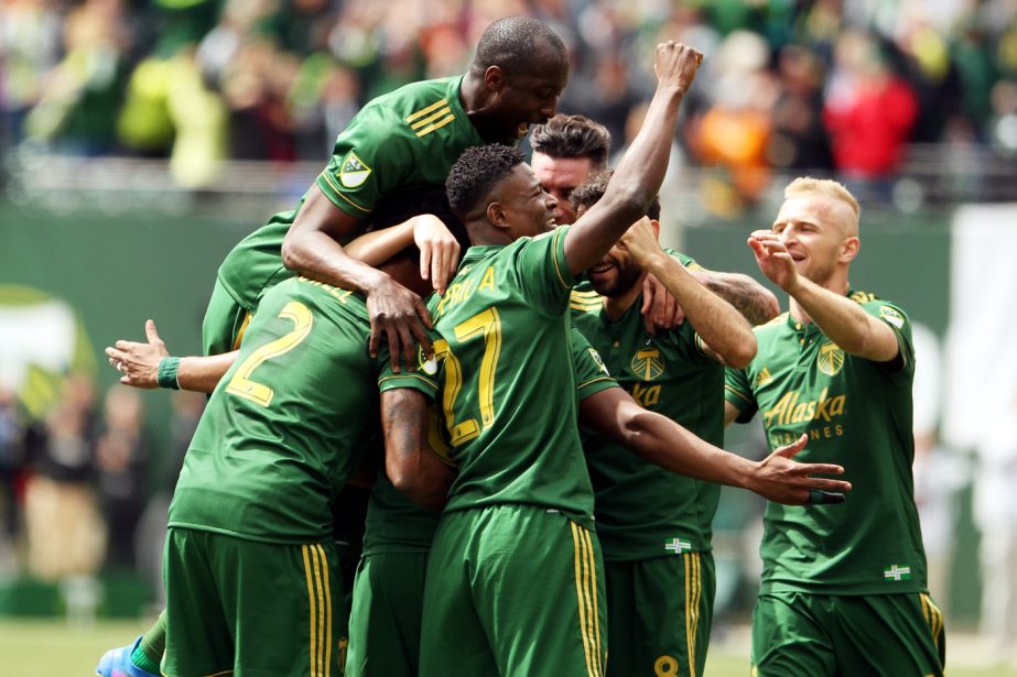 Teammates surround Portland Timbers' Darlington Nagbe following his first-half goal during an MLS soccer game against Vancouver Whitecaps in Portland, Ore on Saturday.