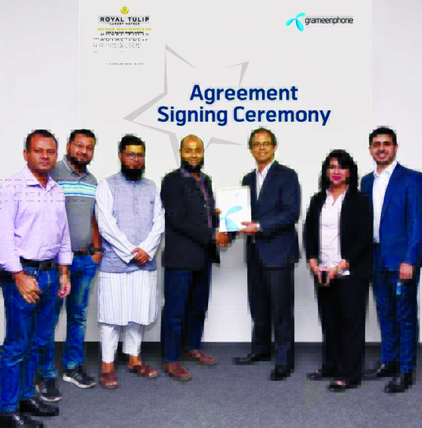 Mohammad Rezwan Chowdhury, Head of HVS of Product Department of Grameenphone and Syed Yameenul Huq, Director of Sales and Marketing of Royal Tulip Sea Pearl Beach Resort & Spa Ltd, located at Inani Beach, Cox's Bazar, exchanging a documents in the city r