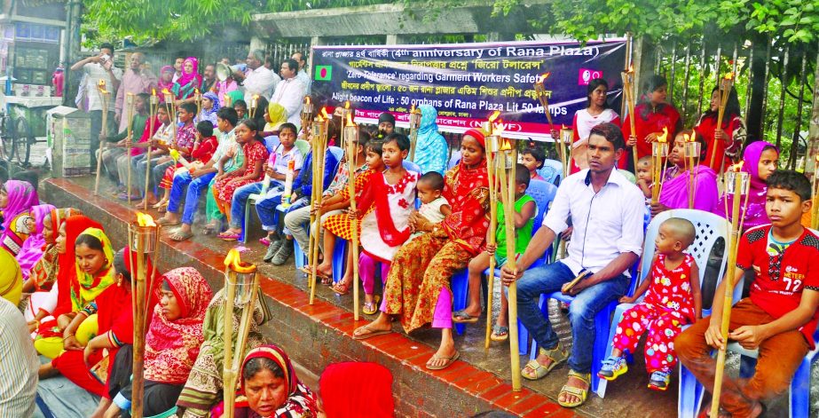 50 orphans lit lamps at a rally organised by Jatiya Garments Sramik Federation in front of the Jatiya Press Club on Monday marking Rana Plaza Tragedy Day.