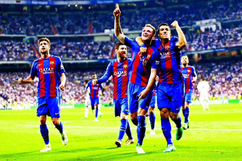 Barcelona's Ivan Rakitic (3rd left) celebrates with Luis Suarez after scoring during a Spanish La Liga soccer match between Real Madrid and Barcelona, dubbed 'el clasico', at the Santiago Bernabeu stadium in Madrid, Spain, on Sunday.