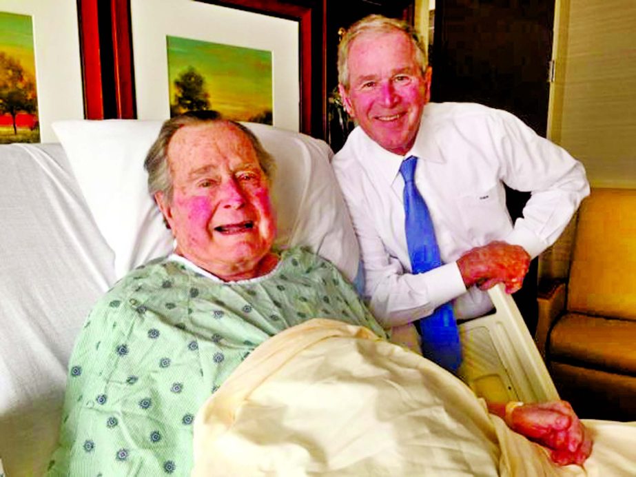 Former president George H.W. Bush (L) is visited in Houston Methodist Hospital by his son George W. Bush as the senior Bush extended his stay in hospital in Houston, Texas, US.