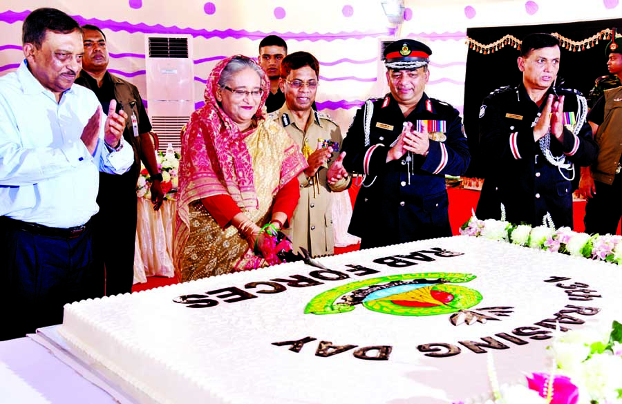 Prime Minister Sheikh Hasina cutting cake marking the 13th founding anniversary of the elite force RAB at its Kurmitola Headquarters in the city yesterday.