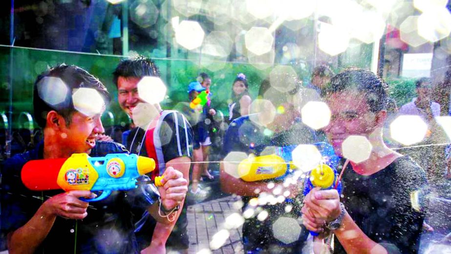 Revellers take part in a water fight at Songkran Festival marking the Thai new year celebrations in Bangkok streets on April 13, 2017. April being the hottest month of the year sees the entire country go bananas in friendly water fights and street parties