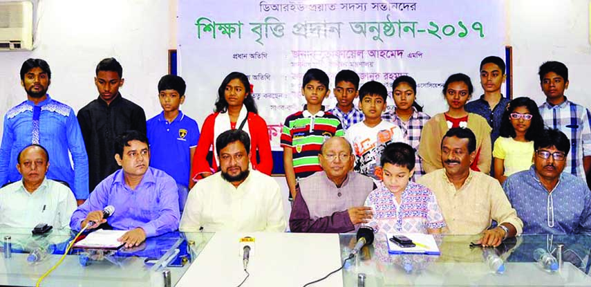 Commerce Minister Tofail Ahmed along with others at the stipend giving ceremony organised for the wards of late members of Dhaka Reporters Unity at its auditorium on Friday.