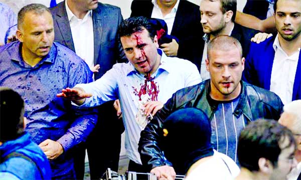Opposition leader of Macedonia Zoran Zaev (centre) after being attacked in parliament.