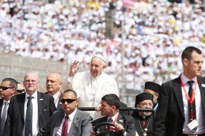 Pope Francis is surrounded by security before the start of a mass on Saturday at a stadium in Cairo