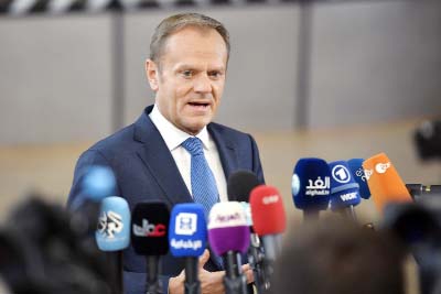 European Council President Donald Tusk speaks with the media as he arrives for an EU summit at the Europa building in Brussels on Saturday.