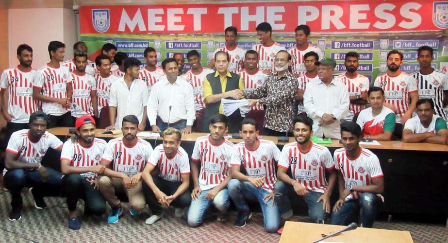 Members of Bangladesh Muktijoddha Sangsad Krira Chakra with the officials of Bangladesh Football Federation (BFF) pose for a photo session after completing their players' transfer window at the BFF House on Saturday.