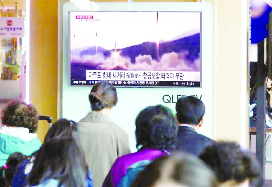 People watch a TV broadcasting of a news report on North Korea's missile launch, at a railway station in Seoul on Saturday.
