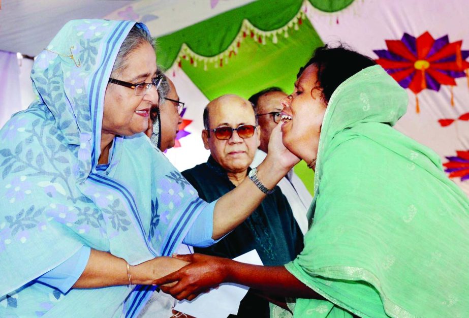 Prime Minister Sheikh Hasina consoling a victim after visiting affected Haor areas at Shalla upazila in Sunamganj on Sunday.
