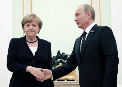 German Chancellor Angela Merkel shaking hands with President Vladimir Putin in Moscow.