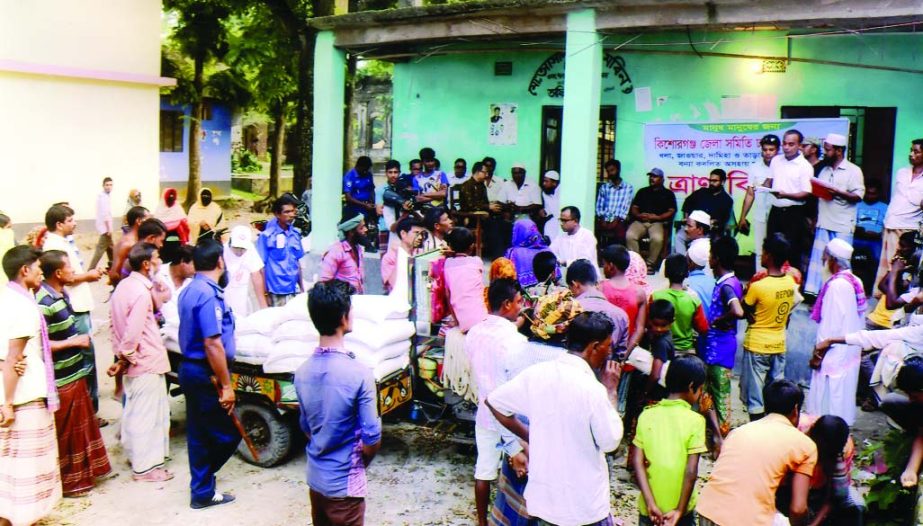 KISHOREGANJ: Kishoreganj Association, Dhaka distributing relief goods among flood-hit haor people in different upazilas. This photo was taken from Dhola area in Tanail Upazila on Sunday.