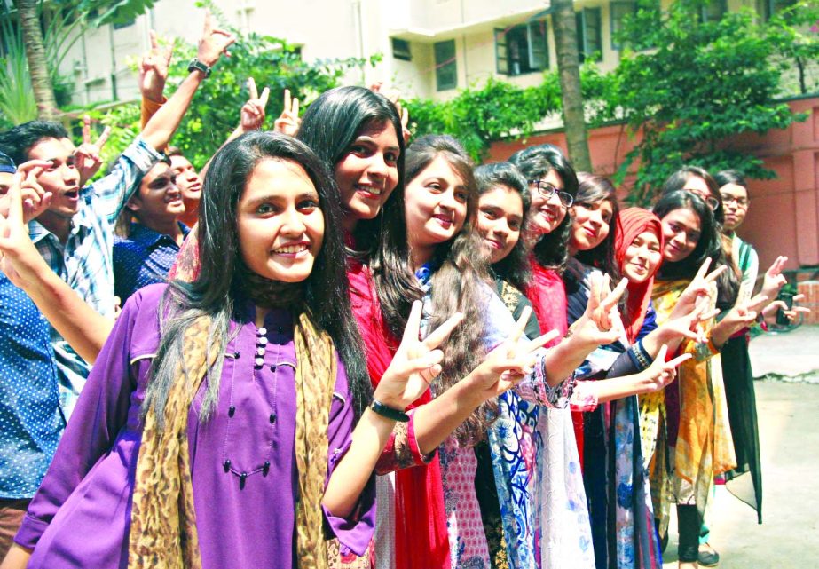 Students of the city's Motijheel Ideal School and College showing victory (V) sign on the premises of their institution on Thursday as they achieved brilliant success in the SSC examination.