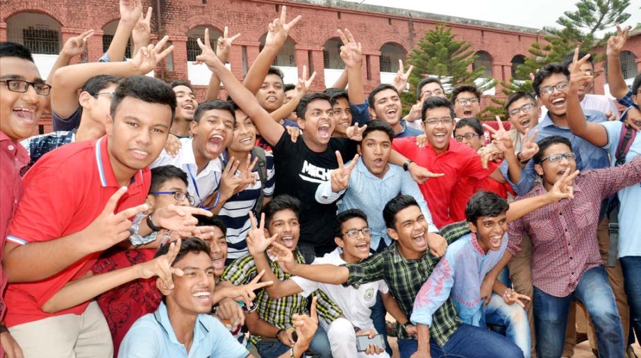 Students who secured GPA-5 in the SSC examination from Chittagong Collegiate School showing V-sign on Thursday.