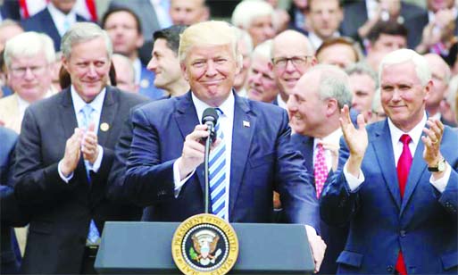 U.S. President Donald Trump Â© gathers with Vice President Mike Pence Â® and Congressional Republicans in the Rose Garden of the White House after the House of Representatives approved the American Healthcare Act, to repeal major parts of Obamacare an