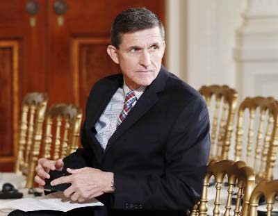 File photo shows the then-National Security Adviser Michael Flynn sits in the East Room of the White House in Washington.