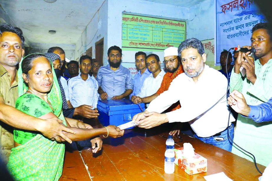 Choudhury Moshtaq Ahmed, Managing Director (CC) of National Bank Limited, distributing financial assistance and free medical treatment to the flood affected Haor people of Sunamgonj District recently. ASM Bulbul, DMD of the bank was also present.