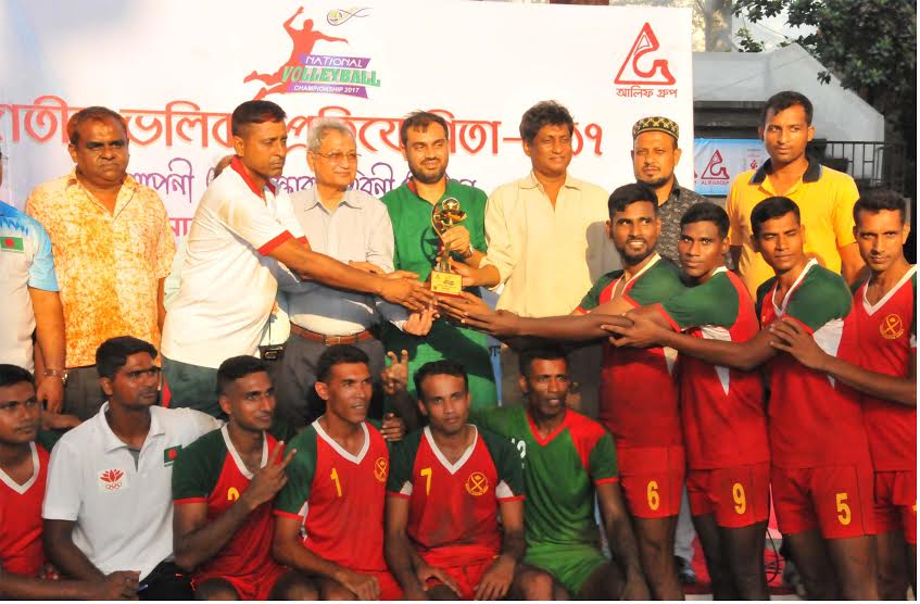 Bangladesh Army, the champions of the services zone of the Alif Group National Volleyball Competition with the officials of Bangladesh Volleyball Federation pose for a photograph at the Volleyball Stadium on Saturday.