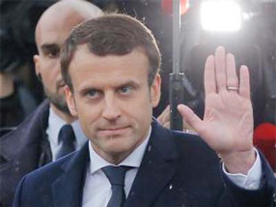 In his political rallies, Macron encourages supporters to wave both the French tricolor and the European Union flags.