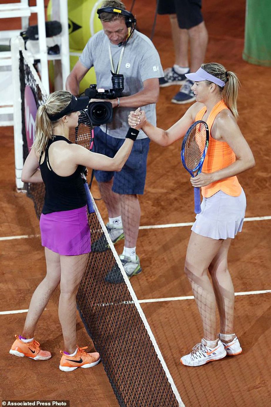 Eugenie Bouchard from Canada (left) shakes hands with Maria Sharapova from Russia at the end of their Madrid Open tennis tournament match in Madrid, Spain on Monday. Bouchard won 7-5, 2-6 and 6-4.