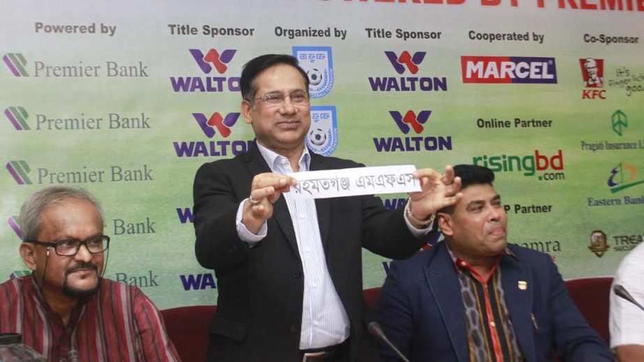 Senior Vice-President of Bangladesh Football Federation (BFF) and Chairman of the Professional Football League Committee Abdus Salam Murshedy showing a name of a team during the draw ceremony of Walton Federation Cup Football at the conference room of BFF
