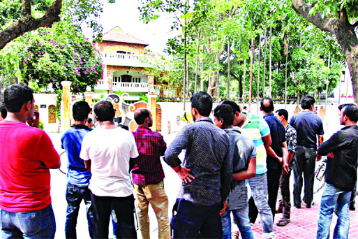 People waiting outside the house of Banani Hotel rape suspect Safat Ahmed, son of the owner of Apon Jewellers' as police raided the house again on Tuesday at Gulshan.