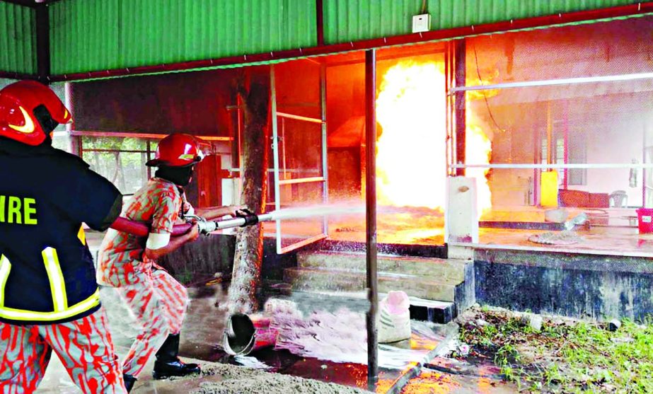 Fire fighters trying to douse the flame that broke out at Oxidization Plant of RAB Training School at Porabari in Gazipur on Tuesday.