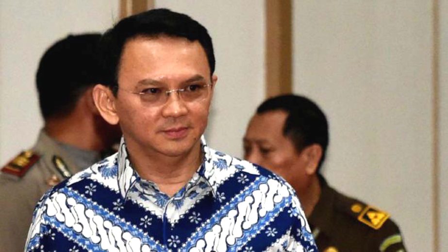 Jakarta Governor Basuki "Ahok" Tjahaja Purnama, center, enters the court room as he attends his sentencing hearing in Jakarta, Indonesia.