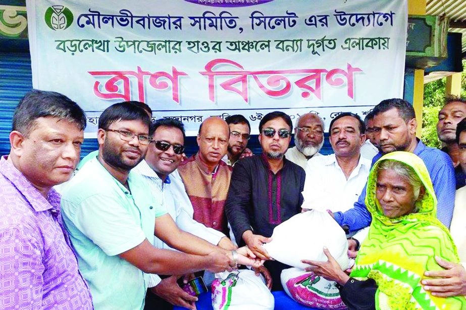 SYLHET: Moulvibazar Samity, Sylhet distributing relief materials among the flood-hit people of Hakaluki Haor area on Saturday.